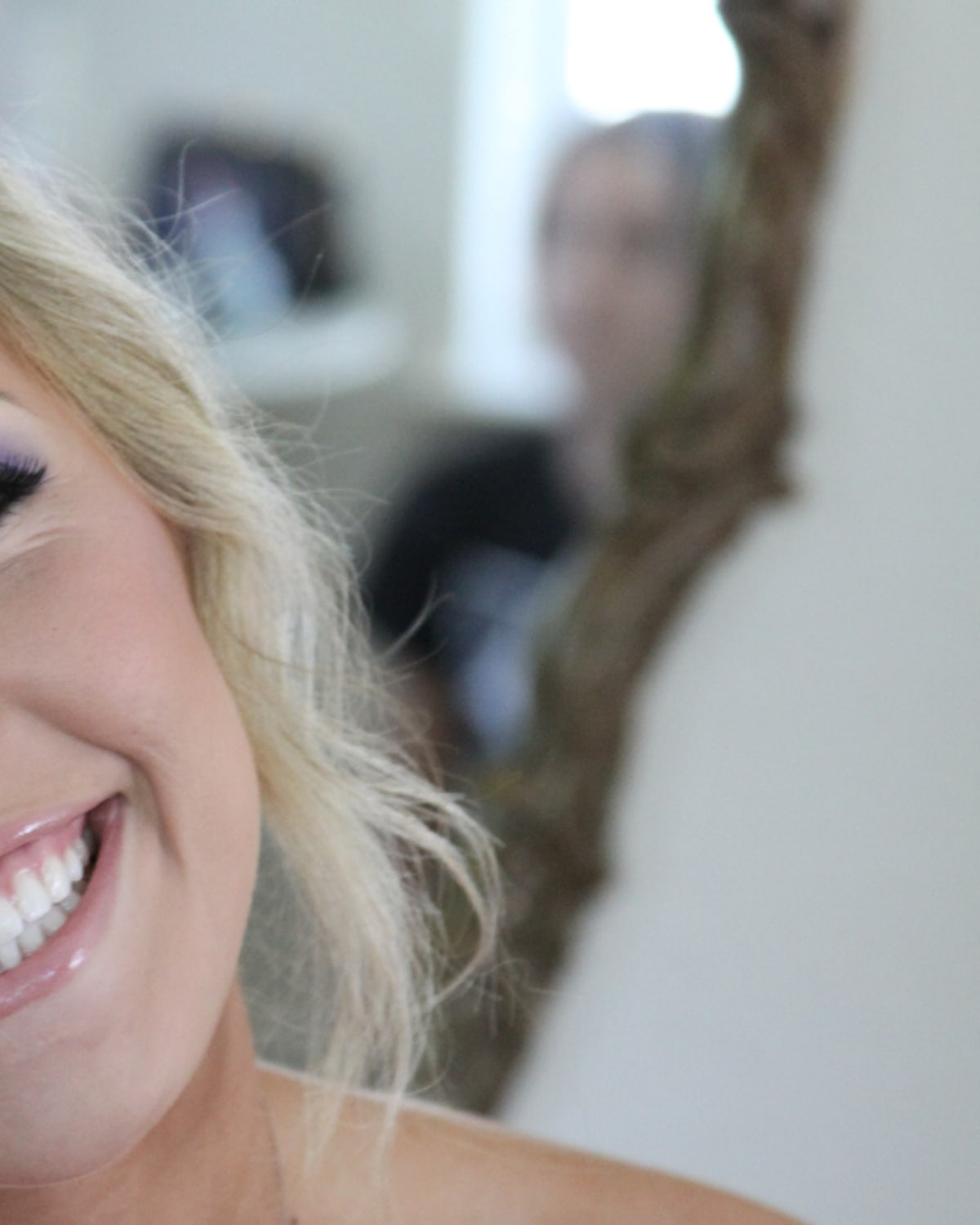 Woman applying makeup quickly at home before leaving for work