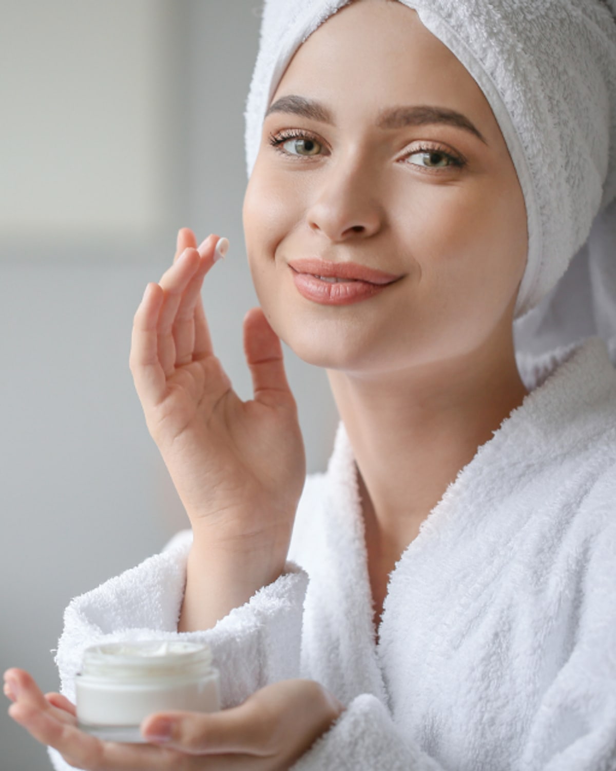 Woman checking sensitive facial skin in natural light
